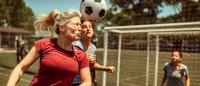 Woman heads a soccer ball